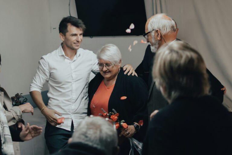 A senior woman enjoying her birthday party with family and friends