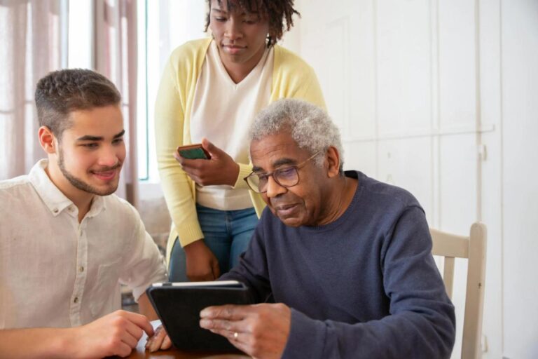 A Medicare beneficiary and caregivers discussing healthcare options at home.