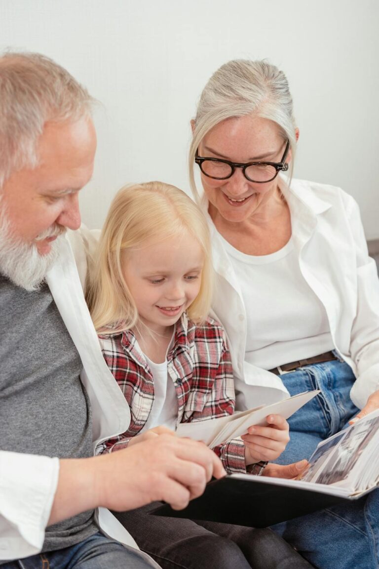 An elderly couple enjoying their retirement with their granddaughter, smiling and spending quality time together.