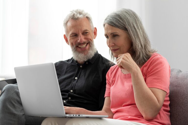 A senior couple reviewing Medicare Advantage benefits together on a laptop.