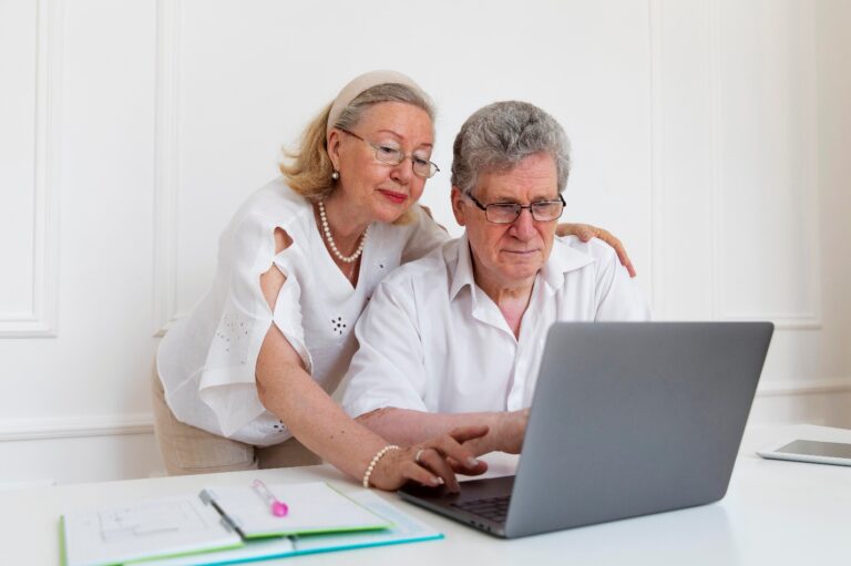 Senior couple reviewing Medicare information on a laptop.