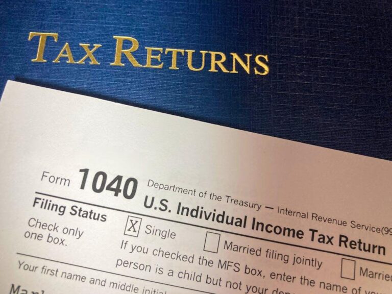 tax return documents on a blue folder