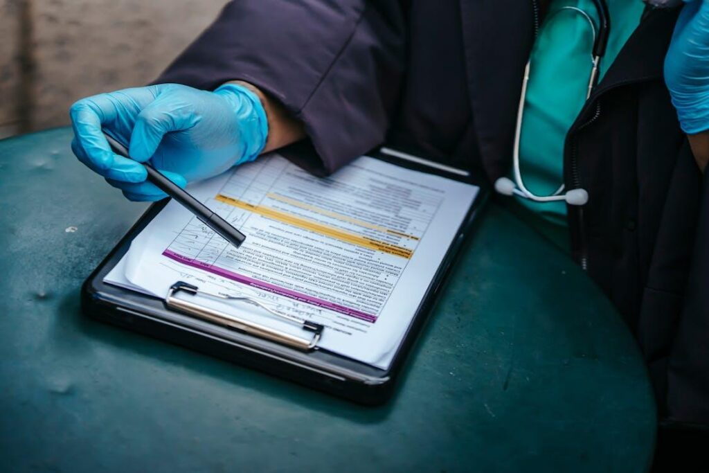 A healthcare professional reviewing medical coverage documents while comparing provider network options.