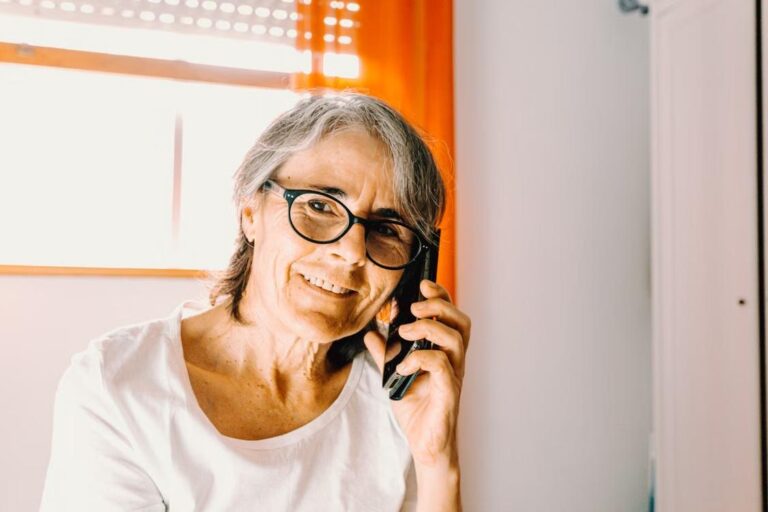 A senior woman talks on her mobile phone.