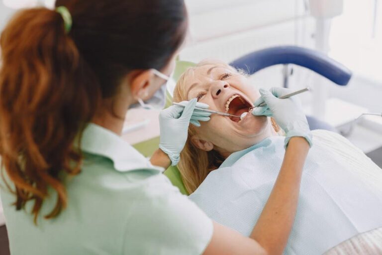 Senior woman receiving a dental examination from a dentist