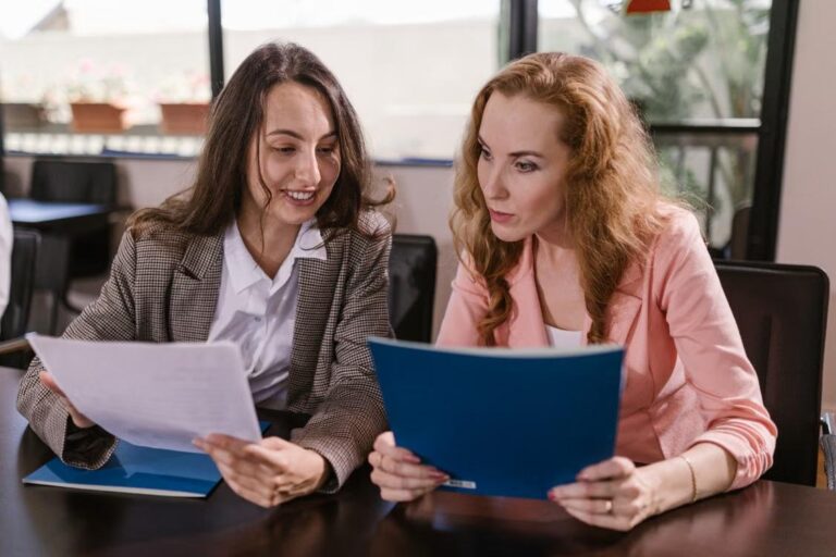 Two people review documents together at a table.